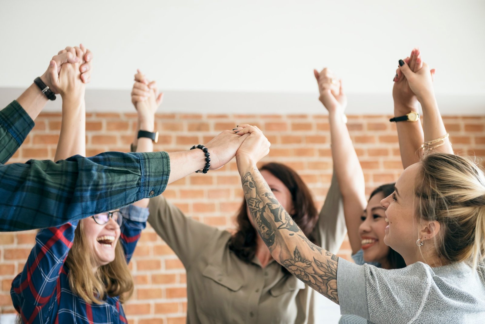 Developer-team-raising-their-hands-up-to-celebrate